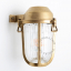 Raw brass marine light for bathroom or outdoor use.