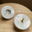 Round white porcelain light switch.