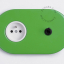 Green outlet & switch with black toggle.