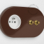 2 gold push buttons on brown integrated outlet