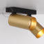 Double surface mounted adjustable spotlight in brass.