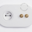 2 gold push buttons on white integrated outlet