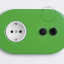 Green outlet & switch with black toggle & pushbutton.