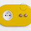 2 gold push buttons on yellow integrated outlet