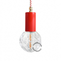 Red pendant light with exposed light bulb.