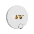 Round white switch with double raw brass toggles.