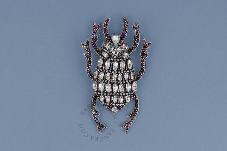 Silver beetle brooch.