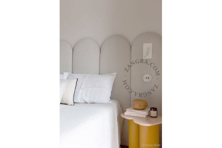 Round white porcelain light switch.