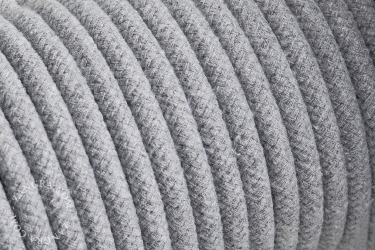 Electrical cable covered in grey cotton.