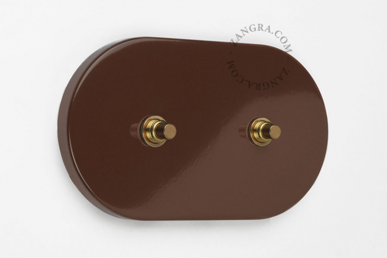 Brown metal double pushbutton switch.