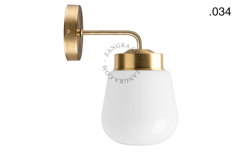 Retro brass wall light with glass shade.