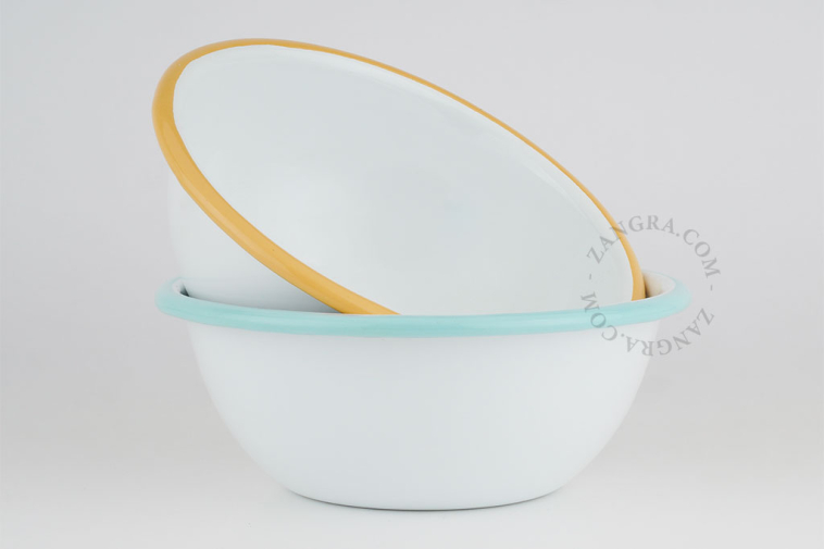 White enamel bowl with light blue rim.