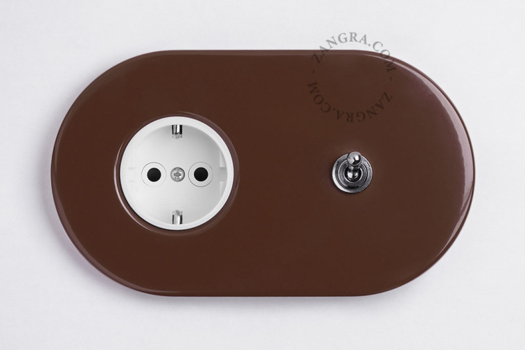 Brown flush mount outlet with switch.