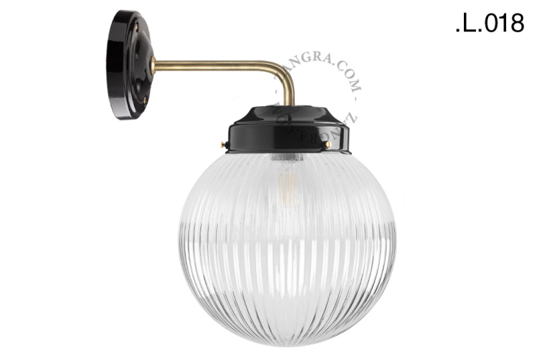 Black and brass retro wall light schoolhouse style with glass shade.