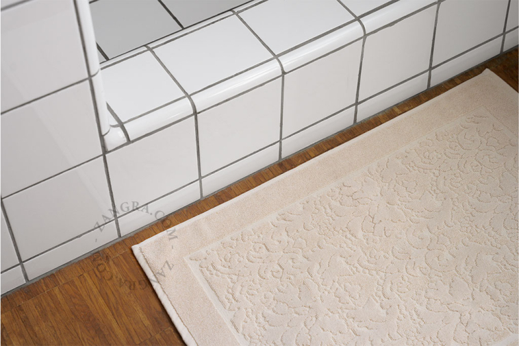 Light brown cotton bathroom mat.