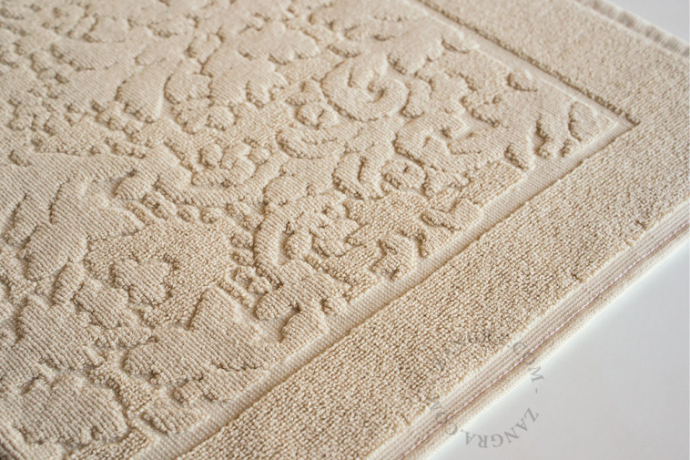 Light brown cotton bathroom mat.