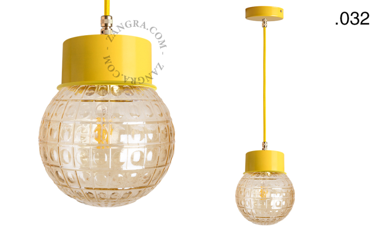 Yellow pendant light with glass shade.