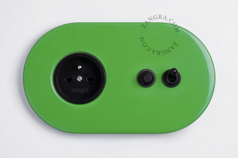Green outlet & switch with black toggle & pushbutton.