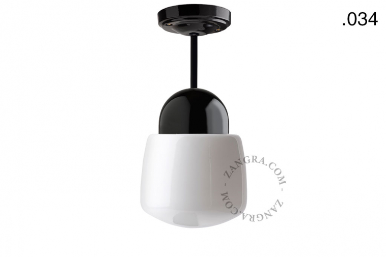 Black porcelain ceiling light with glass shade.