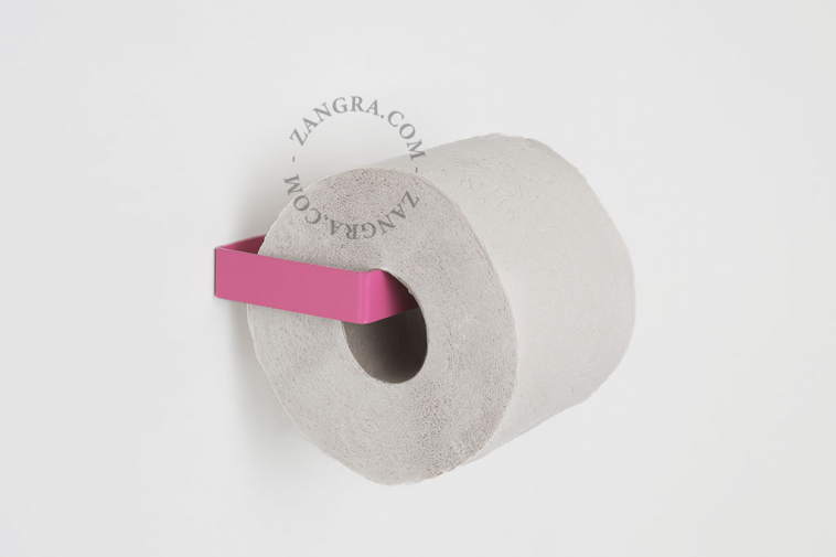 Pink metal toilet paper holder.