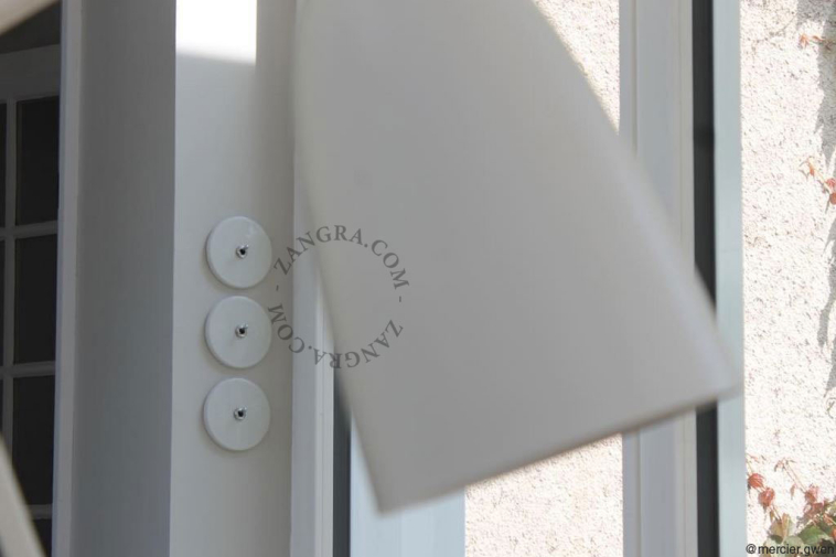 Round white porcelain light switch.