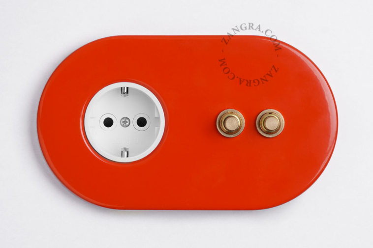2 gold push buttons on red integrated outlet