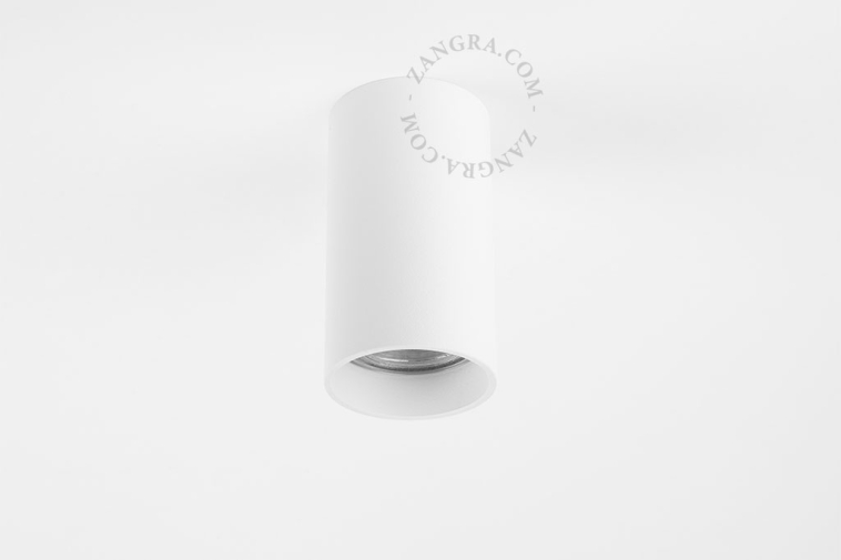 Surface-mounted cylindrical spotlights.