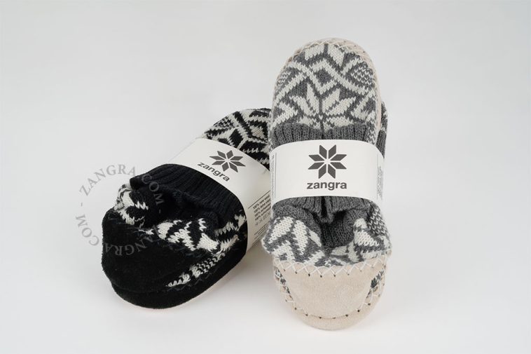 Black knitted slippers with leather sole.