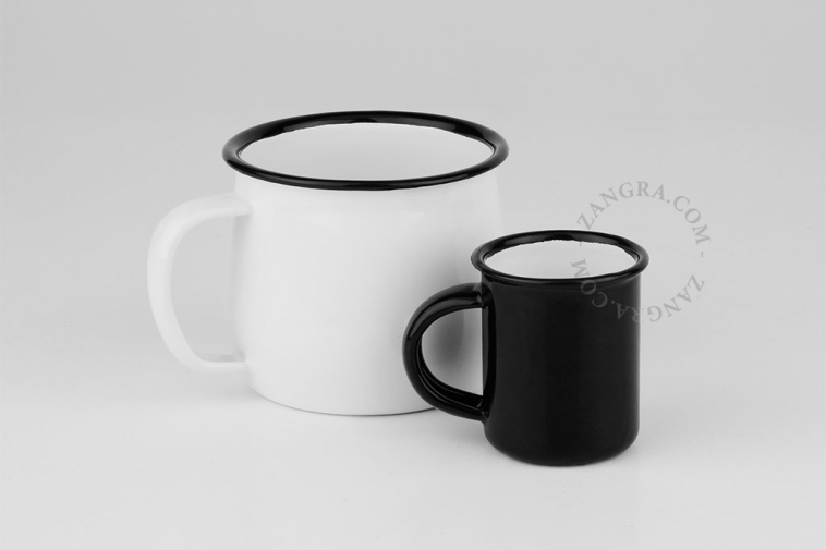 White enamel mug with black rim.