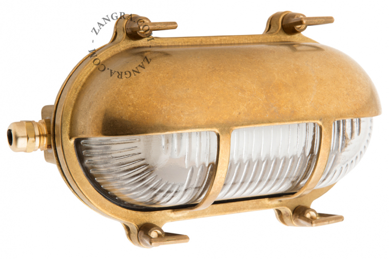 Raw brass ship wall light for outdoor use or bathroom.