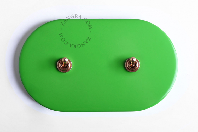 Oval large green double toggle light switch.
