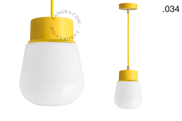 Yellow pendant light with glass shade.