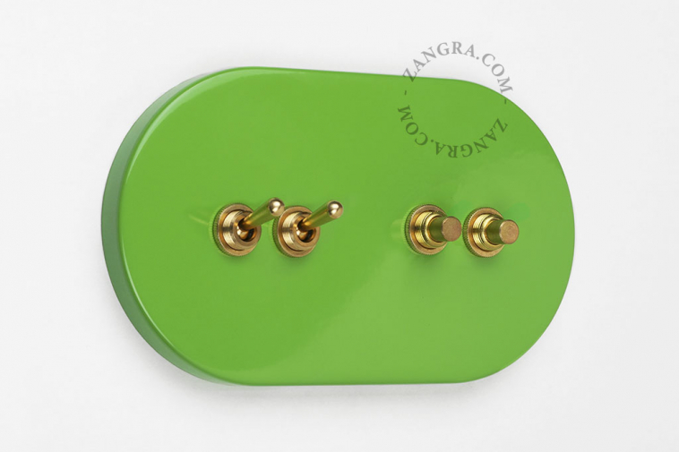 Large light switch with 2 brass pushbuttons and 2 brass toggles.