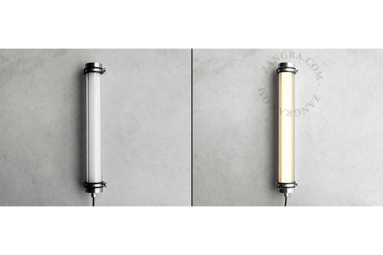 Tubular lamp made of glass and stainless steel.