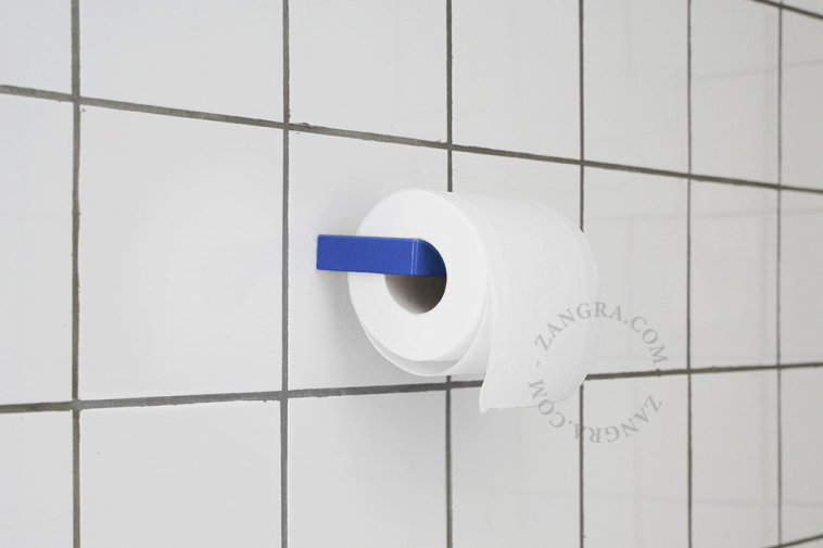 Blue metal toilet paper holder.