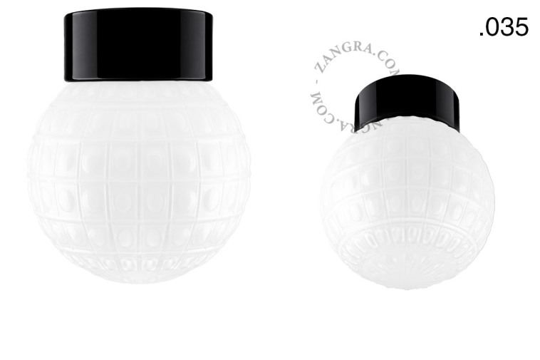 Zwarte porseleinen lamp met glazen schroefkap.