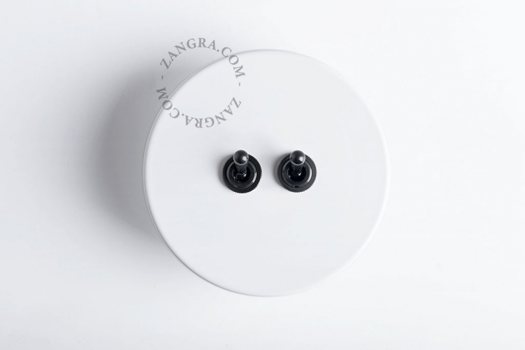 white round double black toggle light switch