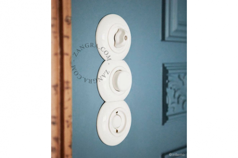 White porcelain cover plate for switches and outlets.