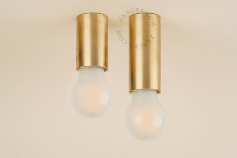 Cylindrical brass light fixture.