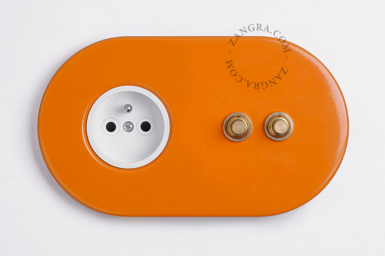 2 gold push buttons on orange integrated outlet
