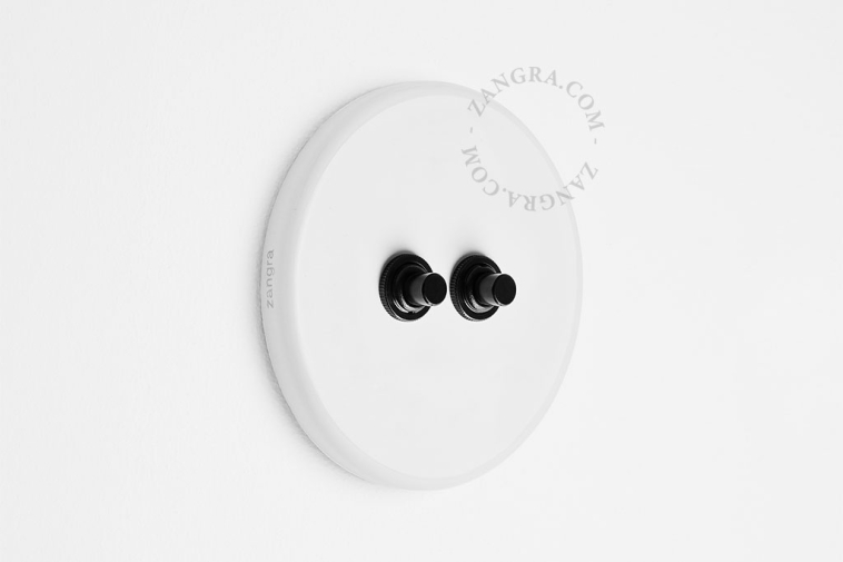 Round white porcelain light switch.