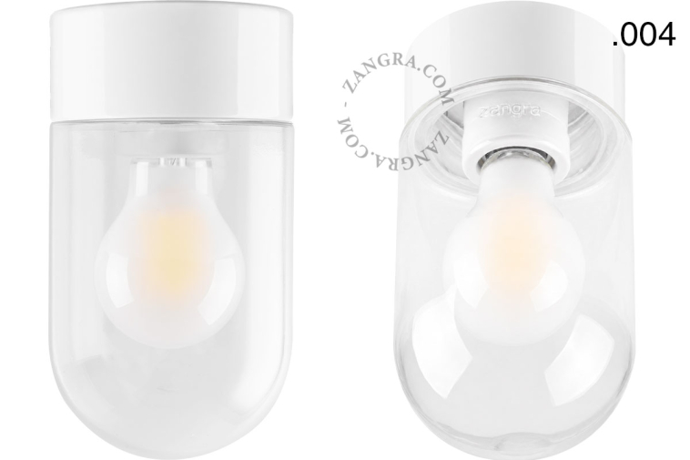 Lampe en porcelaine blanche avec abat-jour en verre.