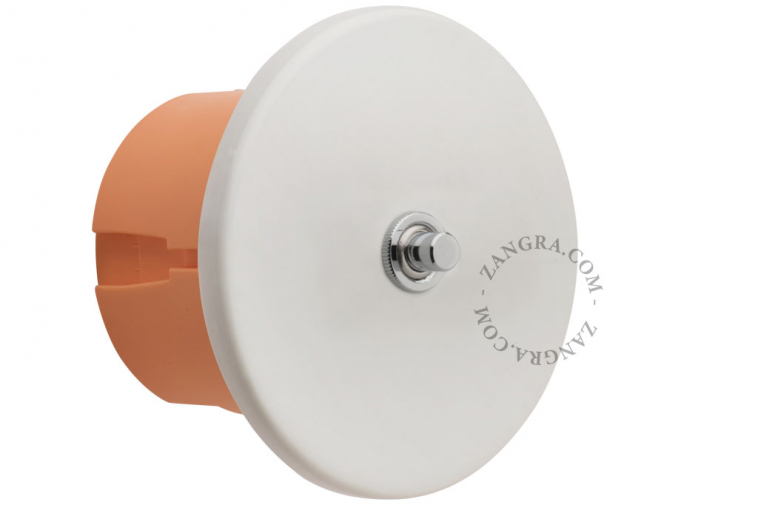 White porcelain switch with nickel-plated pushbutton.