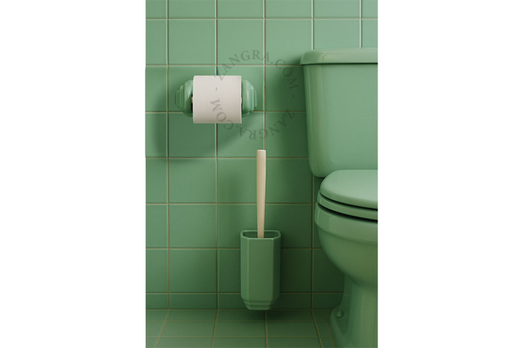 Green porcelain toilet paper holder.