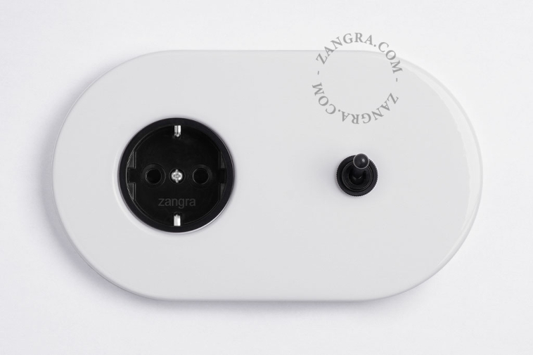 White flush mount outlet & switch with black toggle.