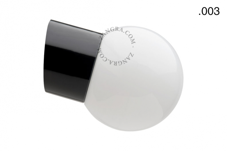 Slanted black porcelain wall light with glass globe.