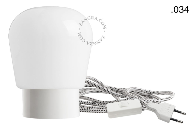 White porcelain table lamp with glass shade.