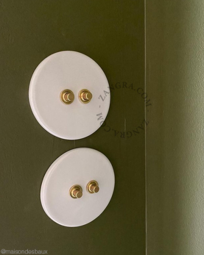 Round white porcelain light switch.