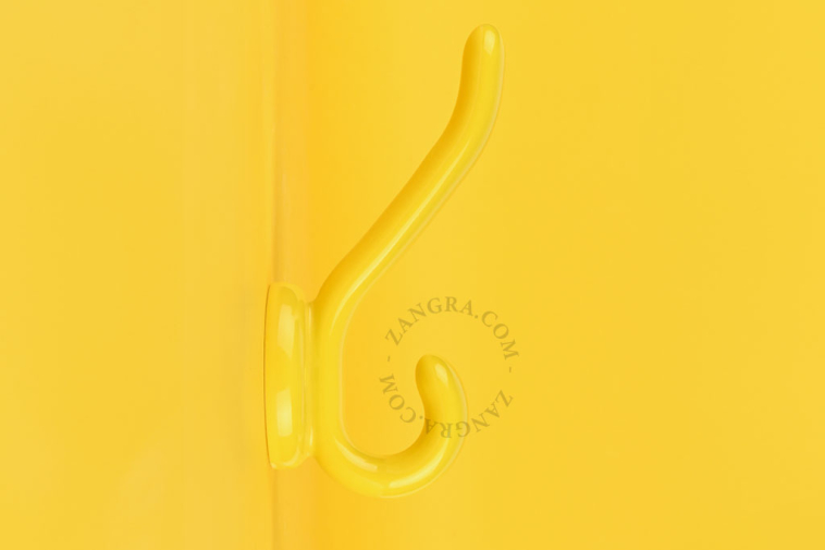 Yellow porcelain double coat hook.