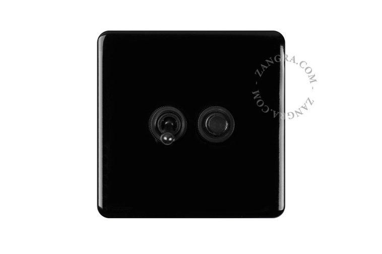 Zwarte lichtschakelaar in porselein.